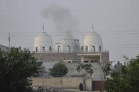 Local residents stand outside a mosque of an Islamic seminary partially damaged by a suspected Indian missile attack, outskirts of Bahawalpur, Pakistan