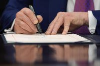 President Donald Trump signs a Congressional joint resolution