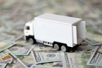 toy moving truck on scattered cash