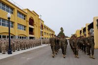 Marines march pass a platoon of new recruits at MCRD San Diego