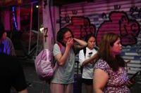 People evacuate after a missile launched from Iran struck Tel Aviv, Israel
