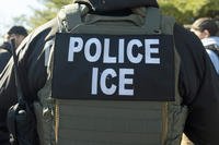 A U.S. Immigration and Customs Enforcement officer listens during a briefing