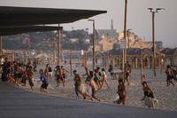 Beachgoers leave during a missile alert from Iran, in Tel Aviv, Israel.