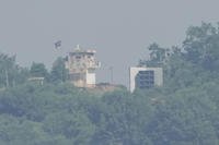 A North Korean military guard post, left, and loudspeaker are seen from Paju, South Korea, near the border with North Korea