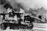 A Bonus Army encampment burns after the U.S. Army attacks WWI veterans protesting their treatment by the federal government.