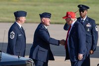 President Donald J. Trump is greeted by Col. Travis Crawmer (center), 132d Wing commander, and Chief Master Sgt. Jason Lehmann (left), 132d Wing command chief, during an official visit to Iowa, July 3, 2025, at the 132d Wing in Des Moines, Iowa.
