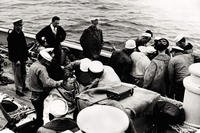 USS Falcon crewmen suit up 2 Navy divers during the rescue operation following the sinking of the USS Squalus.