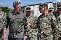 Secretary of the Army, Dan Driscoll, speaks with Brig. Gen. Patrick M. Costello