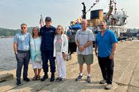 Fredrick Unger's children pose with Seaman Joseph Turk, who saved the 97-year-old