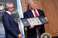 Donald Trump displays a set of 1984 Los Angeles Olympic medals