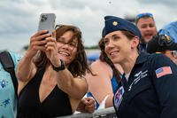 Maj. Michelle Curran, United States Air Force Air Demonstration Squadron ‘Thunderbirds’ lead solo pilot, takes a photo with a fan after performing at the Great Tennessee Air Show in Smyrna, Tennessee.