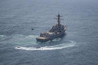 USS Jason Dunham approaches a skiff