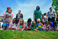 Children that attend the Defense Supply Center Richmond Child Development Center place pinwheels in the ground after a Pinwheel Parade at Defense Supply Center Richmond, Virginia