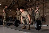 An airman performs a deadlift.