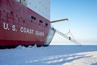 A U.S. Coast Guard Cutter Healy (WAGB 20) crewmember crosses the brow onto the ice while operating in the Arctic Ocean, Oct. 1, 2025. (U.S. Coast Guard photo by Petty Officer 3rd Class Chris Sappey)