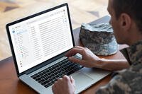 Soldier Using A Laptop To Send An Email
