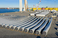 Wind turbine bases, generators and blades are positioned at The Portsmouth Marine terminal at the staging area for Dominion Energy's wind turbine project Monday Dec. 22, 2025, in Portsmouth, Va. (AP Photo/Steve Helber)