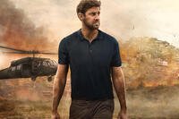 John Krasinski as CIA analyst Jack Ryan stands against a backdrop of a city and military helicopter in Season 2 of Amazon Prime Video’s Tom Clancy’s Jack Ryan. Photo Credit: Amazon Studios