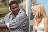 Quinton Aaron and Sandra Bullock sit together in a scene from the 2009 film The Blind Side. Photo credit: Warner Bros. Pictures