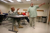 In a Thursday June 4, 2009 photo, Sergeant 1st class Brendon Daniels, left, talks with Music Appreciation teacher Richard Steffen at the SSG Glenn H. English Jr., Army Education Center of Austin Peay University at the Fort Campbell Army Base in Fort Campbell, Ky. (AP Photo/Josh Anderson)