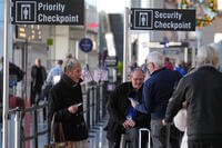 Travelers walk to a security checkpoint at Terminal A at Logan Airport, Tuesday, Dec. 9, 2025, in Boston. (AP Photo/Charles Krupa)