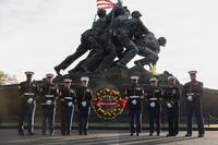 Marines pose with a wreath at the Battle of Iwo Jima memorial.