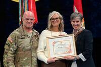 Amy Mingus, pictured in white, receives U.S. Army Julia Compton Moore Lifetime Achievement Award.