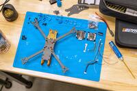 Drone parts on a work surface.