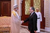 Iranian Foreign Minister Abbas Araghchi, right, shakes hands with Oman's Sultan Haitham bin Tariq
