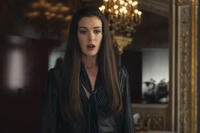 Anne Hathaway in a black outfit standing in an office scene from The Devil Wears Prada 2