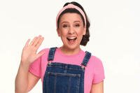 Children’s entertainer Ms. Rachel smiling and waving in a studio portrait. Photo Credit: Penguin Random House