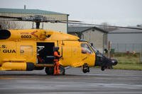 A Coast Guard MH-60 Jayhawk helicopter with a special yellow paint scheme lands at Coast Guard Air Station Astoria, Ore., Jan. 15, 2016. (Coast Guard/Jonathan Klingenberg)