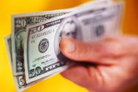 Hand holding cash.