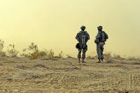 Two soldiers patrolling the desert.