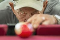 Vietnam veteran Jim Alderman lines up a shot during a game of pool in the recreation room at the inpatient post-traumatic stress disorder clinic at the Bay Pines Veterans Affairs Medical Center in Bay Pines, Fla. (DoD photo by EJ Hersom)