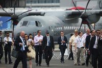 People walk around on day four of the Farnborough International Airshow on July 16, 2014, in Farnborough, England. The show is the biggest event of its kind and attracts people from all over the world. (Getty Images)