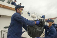 Crewmembers aboard the Coast Guard Cutter Richard Etheridge, a 154-foot Sentinel-class Fast Response Cutter homeported at Sector Miami, offload approximately 1,500 pounds of cocaine, worth an estimated wholesale value of $23 million, in St. Petersburg, Fl