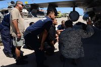 Tech Sgt. Arnell Dorn shows Saipan firefighters different parts of an F-16 Fighting Falcon during training Feb. 12, 2015, at the Saipan International Airport in the Commonwealth of Northern Marianas Islands. U.S. Air Force/Senior Airman Cierra Presentado