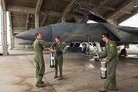 U.S. Air Force Lt. Col. Alexander Haddad, 44th Fighter Squadron pilot, gets sprayed with water by 1st Lts. Maxwell Anthony (left) and Michael Tope, 44th FS pilots, after Haddad reached 2,000 F-15 flying hours. (U.S. Air Force/A1C Corey M. Pettis)