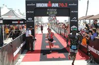 Marine Corps Staff Sgt. Kenneth Bell, right, finishes the 2015 Ironman 70.3 SuperFrog triathlon event in Coronado, Calif., Sept. 27, 2015. (Photo: U.S. Department of Defense)