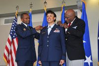 Gen. Darren W. McDew and Hillard W. Pouncy, original Tuskegee Airman, pin stars on then Maj. Gen. Stayce D. Harris, during a promotion ceremony Aug. 9, 2014 at Dobbins Air Reserve Base, Ga. (U.S. Air Force photo/Staff Sgt. Jaclyn McDonald)
