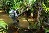 A U.S. Soldier crosses a stream during the 12-day Australian Army Junior Leader Jungle Training Course, July 30 to Aug. 10, in Queensland, Australia. (US Army)