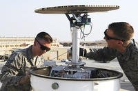 Staff Sgt. Gregory Evenson and Senior Airman David Baily, 386th Expeditionary Operations Support Squadron weather forecasters, conduct a preventative maintenance inspection on a Doppler radar system. (U.S. Air Force/Staff Sgt. Tyler Alexander)