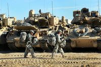 Soldiers of 1st Armored Brigade Combat Team, 1st Cavalry Division carry bags to vehicles during a final preparation in advance of &quot;roll out&quot; to the training area at the National Training Center at Fort Irwin, Calif., Oct. 8. (Photo: Mr. Gustavo Bahena)