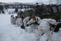 U.S. Marines with Company G, 2nd Battalion, 2nd Marine Regiment, 2nd Marine Division dig a path for a Bandvagn 206 to move through the snow in Giskaas, Norway (Photo By: Lance Cpl. Cesar N. Contreras)
