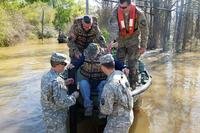 Soldiers help a flood victim from a special rescue boat in Ponchatoula, La., March 13, 2016. The soldiers are assigned to the Louisiana National Guard’s 2225th Multi-Role Bridge Company. (Louisiana National Guard/1LT Rebekah Malone)