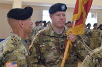 Lt. Col. Marc Pelini receives the 6th Battalion, 52nd Air Defense Artillery Regiment colors from Col. Mark Holler, 35th ADA Brigade commander, during a change of command ceremony at Suwon Air Base, South Korea, July 7. (U.S. Army/Capt. Jonathon Daniell)
