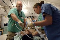 Air Force personnel care for a patient at Balad Air Base, Iraq in October 2006. (Air Force photo/Scott Wagers)