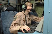Senior Airman Whitni Orgass, 41st Expeditionary Electronic Combat Squadron cryptological language analyst, works at her station aboard an EC-130 Compass Call aircraft on Bagram Airfield, Afghanistan. (U.S. Air Force photo by Staff Sgt. David Dobrydney)