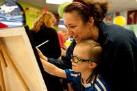 A mother and son paint during a Exceptional Family Members Program (EFMP) event at Peterson Air Force Base, Colorado. (Photo: U.S. Air Force/Senior Airman Tiffany DeNault.)
